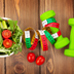 Dumbells, tape measure and healthy food. Fitness and health